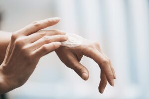 woman-applying-moisturizing-cream-on-hands-2021-08-27-13-38-44-utc